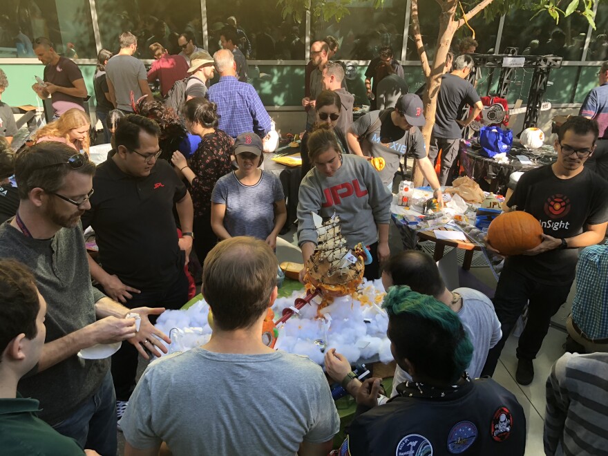 Mechanical engineers finish carving their pumpkins at JPL's annual competition.