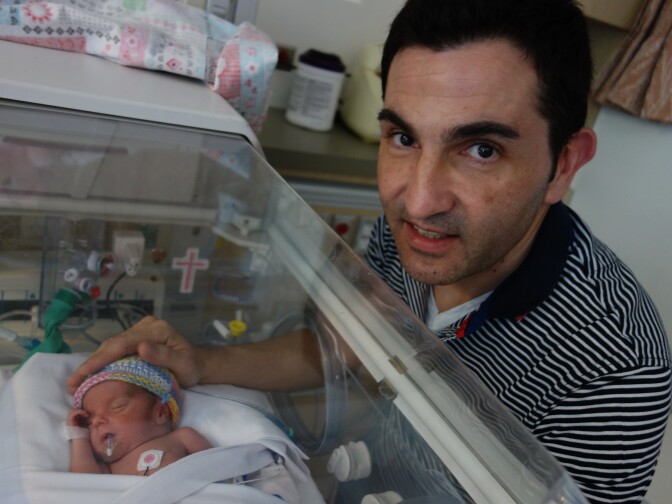 Izquierdo Saturnino with his tiny daughter Francesca in the neonatal intensive care unit at Miller Children's Hospital in Long Beach. Francesca is one of a set of prematurely born triplets receiving care at the NICU.