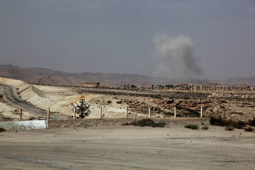 Smoke rises after a Syrian Rocket launcher shell on Islamic State positions in the ancient oasis city of Palmyra, about 215 kilometers northeast of Damascus on Tuesday. News reports say the Islamic State has taken control of the city.