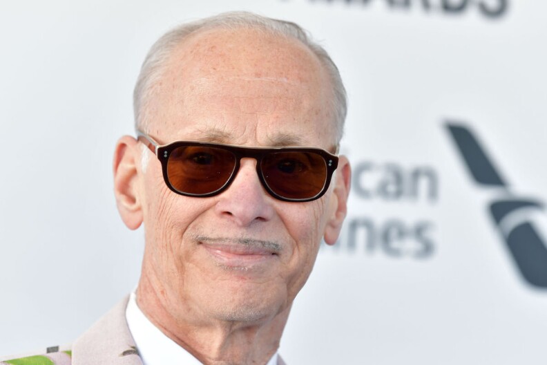 A close-up shot of John Waters in sunglasses.