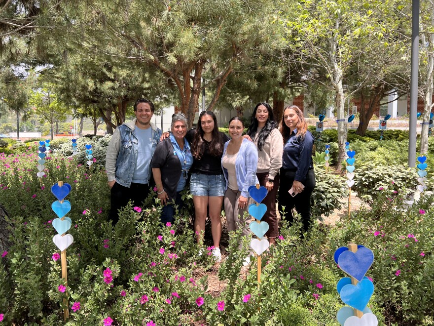 Six members of Mt. SAC's REACH program stand in the commemorative garden, which has blue hearts representing over 400,000 foster youths in the U.S. this year.