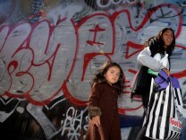 Three year old Saria Amaya (L) waits with her mother after receiving shoes and school supplies during a charity event to help more than 4,000 underprivileged children at the Fred Jordan Mission in the Skid Row area of Los Angeles on October 2, 2014. Skid Row reportedly contains one of the largest populations of homeless people in the United States.                  AFP PHOTO/Mark RALSTON        (Photo credit should read MARK RALSTON/AFP/Getty Images)