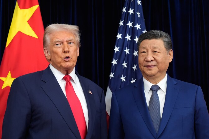 Donald Trump, left, and Xi Jinping stand next to each other in front of U.S. and China flags.