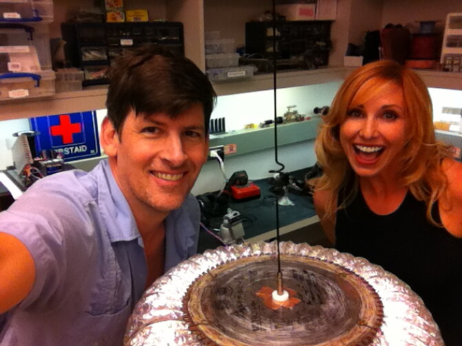 Off-Ramp host John Rabe, KPCC Chief Engineer Lance Harper's Tesla coil, and Mythbuster Kari Byron, in the KPCC engineering shop on Nicolai Tesla's 158th birthday.