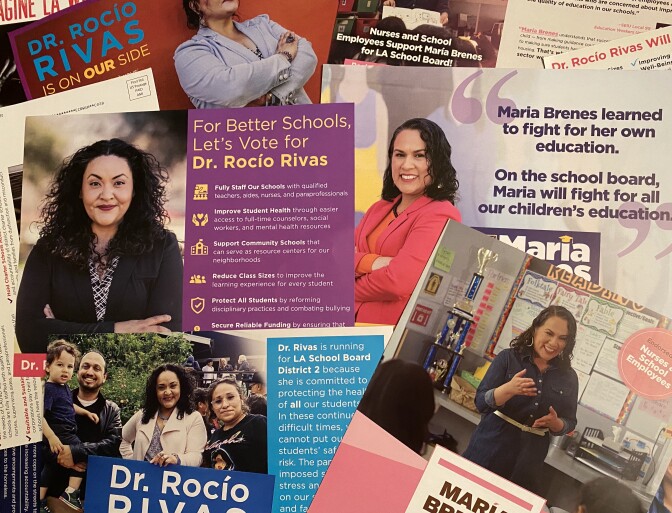A series of campaign mailers, all printed on glossy cardstock pages, are spread on the floor. Both feature women posed smiling toward the camera and campaign messages for the candidates, Rocío Rivas and María Brenes.