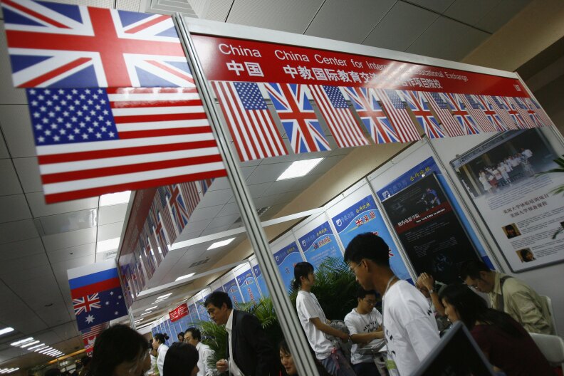 Visitors inquire about schools of USA, UK and other countries at the 2006 China Education Expo on October 14, 2006 in Beijing, China. The fair has attracted over 450 colleges, universities, schools and institutions from about 30 countries and regions present. Chinese students have become popular student source for foreign schools which are developing overseas education market in China, according to local media.