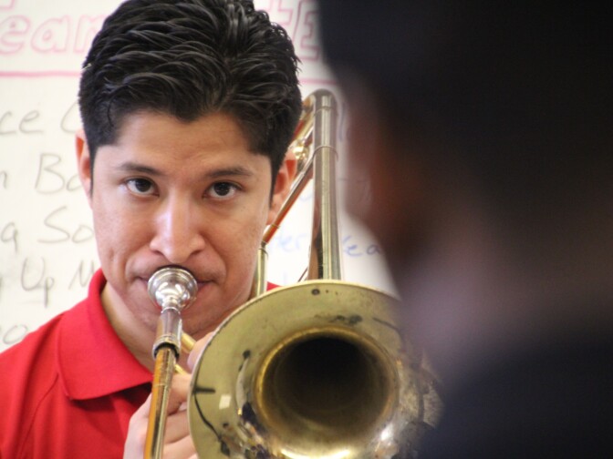 Christopher Herrero, a tuba player at Karr a decade ago, was hired as band director four years ago.