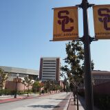 A young man rides a bicycle on the campus of the University of Southern California (USC) in Los Angeles, California on May 17, 2018. - USC was in turmoil as it was accused of being too slow to act on accusations of abusive sexual practises by Dr. George Tyndall. A gynaecologist who saw student patients at the Engemann Student Health Center.  USC has already received more than 85 current and former student testimonies accusing Tyndall of abuse during examinations. (Photo by Robyn Beck / AFP)        (Photo credit should read ROBYN BECK/AFP/Getty Images)