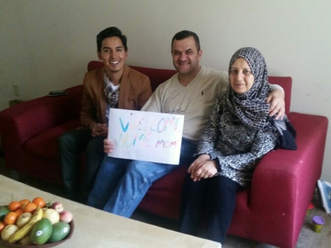 Jose Serrano of World Relief, a refugee resettlement agency with an office in Garden Grove, sits with Isam Zabiba and Masaya Witwit the day after her arrival from Iraq.