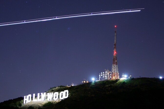 The Hollywood Sign is illuminated by the spotlight of a helicopter streaking past the sign at night on November 16, 2005 in Los Angeles, California.