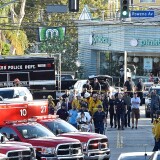 TOPSHOT - Police officers and members of the Los Angeles Fire Department escort a woman on a stretcher after a suspect barricaded inside a Trader Joe's supermarket in Silverlake, Los Angeles, on July 21, 2018. - A suspect wanted in connection with a shooting was barricaded inside a supermarket in the US city of Los Angeles on Saturday, police said, in what US media reported was a possible hostage situation. (Photo by Robyn Beck / AFP)        (Photo credit should read ROBYN BECK/AFP/Getty Images)