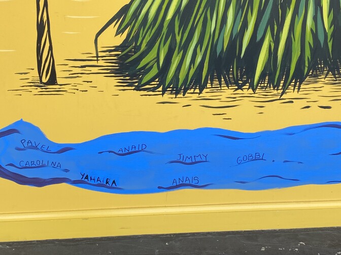 Another close up of the mural reveals student names written on the blue water. 
