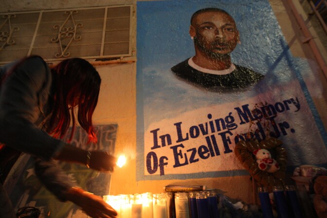 LOS ANGELES, CA - DECEMBER 29: Tritobia Ford lights candles at a memorial for her son, Ezell Ford, a 25-year-old mentally ill black man, at the site where he was shot and killed by two LAPD officers in August, on December 29, 2014 in Los Angeles, California. The long-awaited autopsy report, which was put on a security hold at the request of police and ordered by L.A. Mayor Eric Garcetti to be made public before the end of 2014, was released December 29.   (Photo by David McNew/Getty Images)