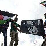 Kashmiri demonstrators hold up Palestinian flags and a flag of the Islamic State of Iraq and the Levant (ISIL) during a demonstration against Israeli military operations in Gaza, in downtown Srinagar on July 18, 2014.