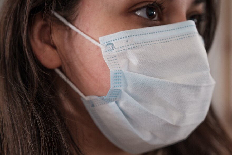 A woman wears a face mask.