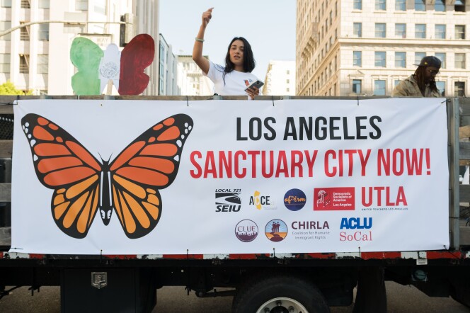 A person on a truck with a sign in front.