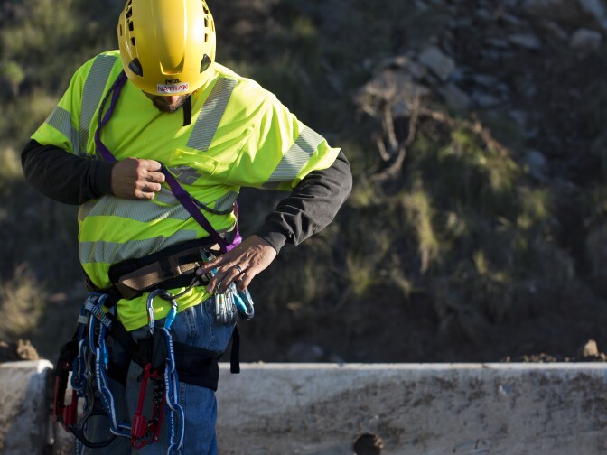 Nathan Arredondo and the CalTrans trained rock climbing team prepare for a day of removing loose rocks on a mountainside along Pacific Coast Highway on Tuesday morning, Jan. 6. The rocks came loose after the Springs Fire in May 2013.