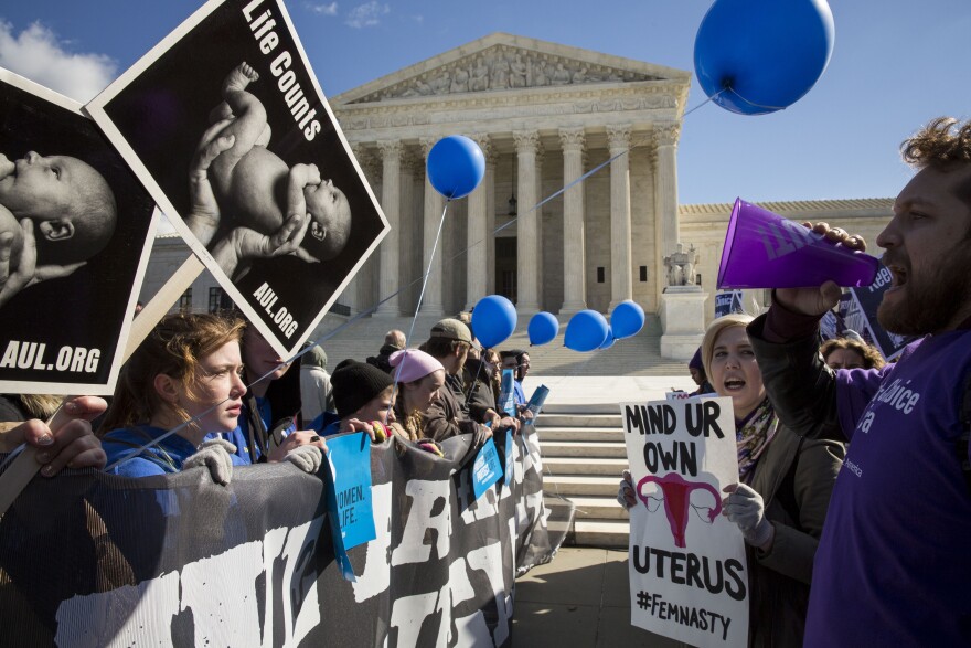 WASHINGTON, DC - MARCH 2: Pro-choice advocates (right) and anti-abortion advocates (left) rally outside of the Supreme Court, March 2, 2016 in Washington, DC.  On Wednesday morning, the Supreme Court will hear oral arguments in the Whole Woman's Health v. Hellerstedt case, where the justices will consider a Texas law requiring that clinic doctors have admitting privileges at local hospitals and that clinics upgrade their facilities to standards similar to hospitals. (Drew Angerer/Getty Images)