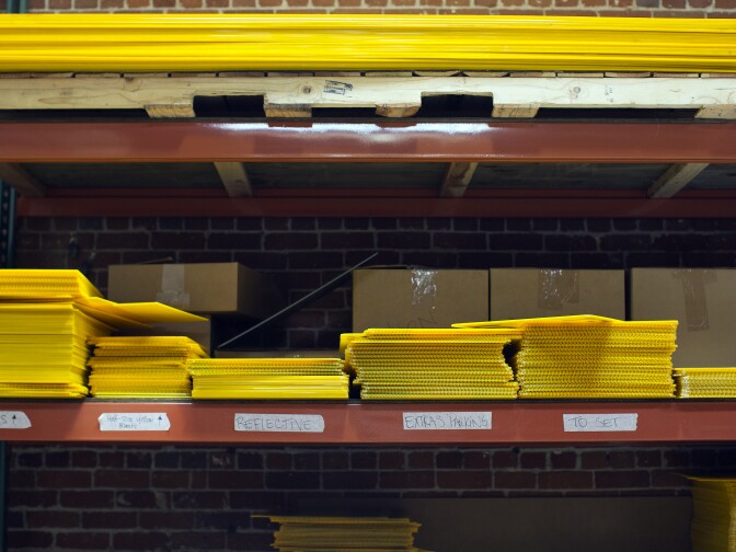 The yellow signs are pre-made with arrows and messages like "crew parking," extras" and "to set." Once an order comes in, the logos and titles of the production are printed and adhered to the signs.