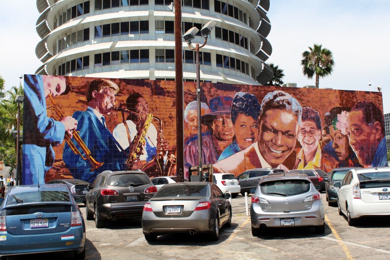 "Hollywood Jazz: 1945-1972," also known as the Capitol Records Jazz Mural, on the south wall of the Capitol Records Building, painted by artist Richard Wyatt in 1990. The mural depicts Billie Holiday alongside Chet Baker, Gerry Mulligan, Charlie Parker, Tito Puente, Miles Davis, Ella Fitzgerald, Shelly Manne, Dizzy Gillespie, Duke Ellington and Nat "King" Cole.