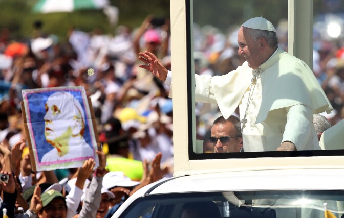 Pope Francis waves from the popemobile as he arrives to celebrate a Mass in  in Samanes Park, in Guayaquil, Ecuador, Monday, July 6, 2015. Latin America's first pope arrived in this port city on Monday for the first big event of a three-nation tour where he's set compassion for the weak and respect for the environment as central themes. (AP Photo/Fernando Vergara)