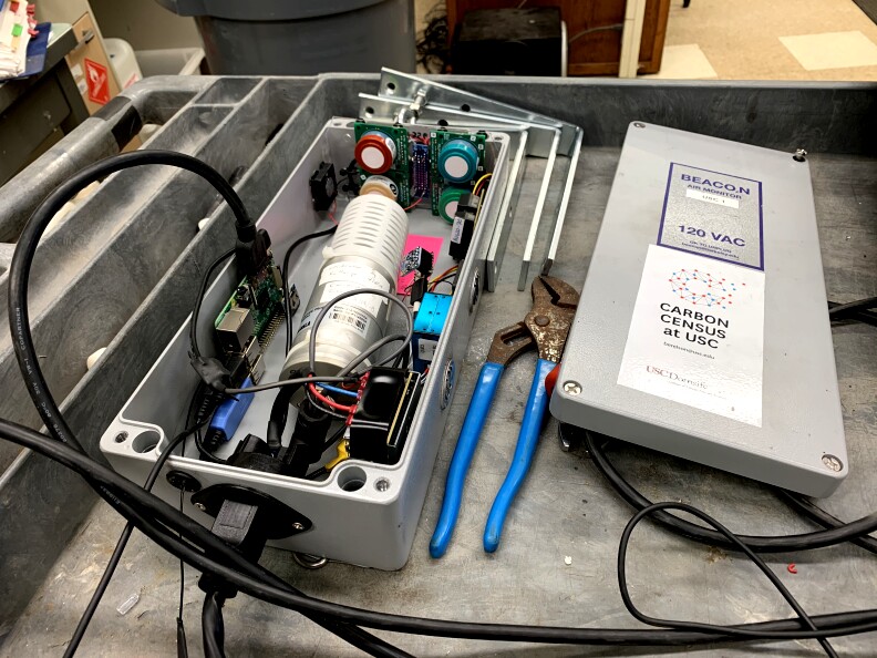 The opened grey box, about the size of a shoebox showing the sensors that will post pollution data automatically to the website.