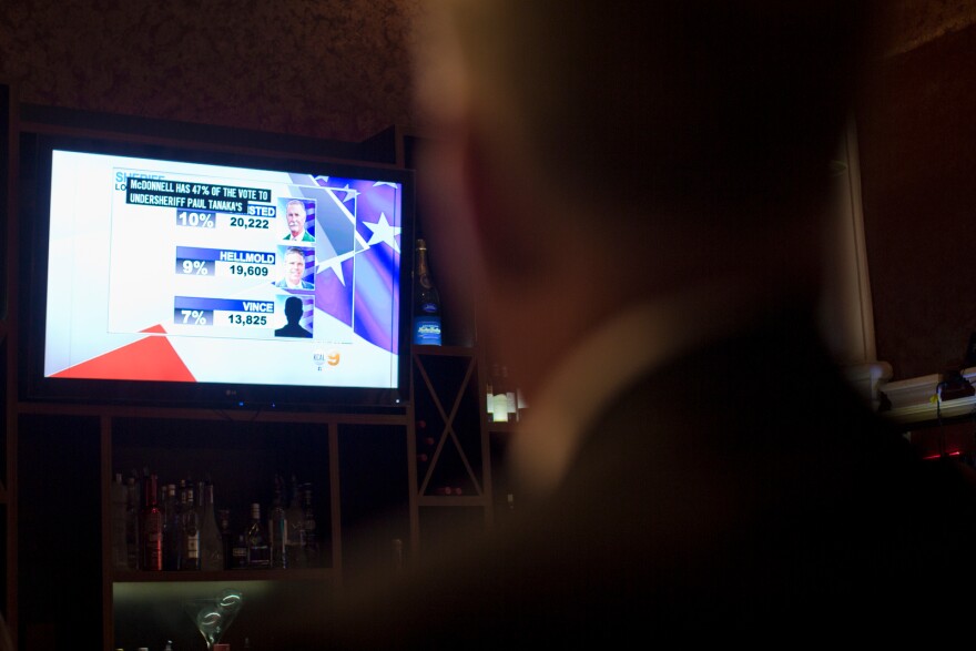 Los Angeles County Sheriff candidate Bob Olmsted watches local television as results come in at Pierre Garden in Glendale on Tuesday night, June 3.