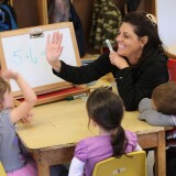 Teacher Denise Severing congratulates a child during a math lesson at the federally-funded Head Start school on September 20, 2012 in Woodbourne, New York. A California judge has struck down  teacher tenure protection, seniority-based job protection and existing disciplinary policy in a groundbreaking case for education equality.