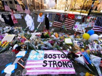 Items are placed by people visiting a makeshift memorial for victims near the site of the Boston Marathon bombings at the intersection of Boylston Street and Berkley Street two days after the second suspect was captured  on April 21, 2013 in Boston, Massachusetts. A manhunt for Dzhokhar A. Tsarnaev, 19, a suspect in the Boston Marathon bombing ended after he was apprehended on a boat parked on a residential property in Watertown, Massachusetts. His brother Tamerlan Tsarnaev, 26, the other suspect, was shot and killed after a car chase and shootout with police. The bombing, on April 15 at the finish line of the marathon, killed three people and wounded at least 170.  