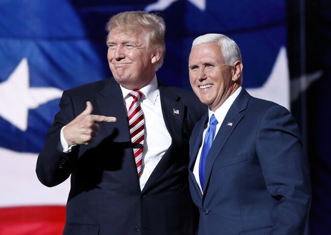Republican presidential candidate Donald Trump, points toward Republican vice presidential candidate Indiana Gov. Mike Pence after Pence's acceptance speech during the third day session of the Republican National Convention in Cleveland, Wednesday, July 20, 2016. (AP Photo/Mary Altaffer)