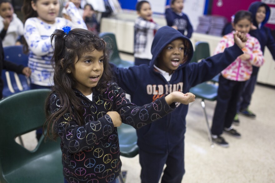 First graders Sherlyn Asuna, left, and Jaden Armstrong practice a holiday song at Martin Luther King Elementary School in Compton on Friday morning, Dec. 5, 2014.