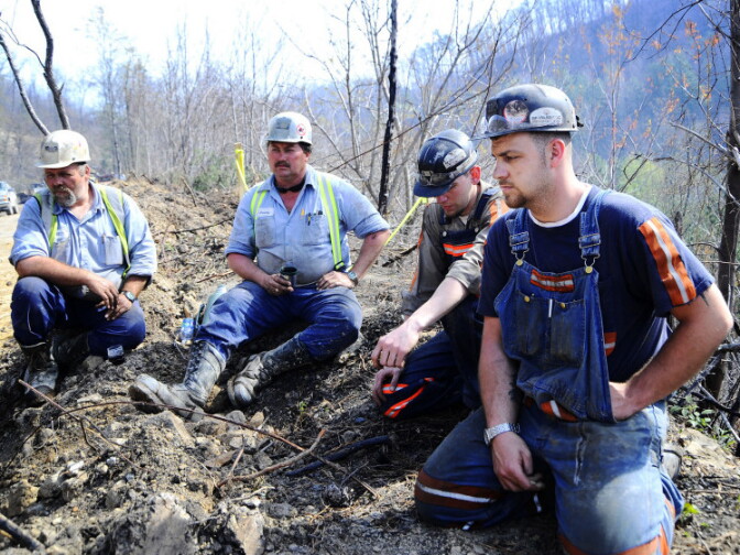 Massey Energy workers take a break from drilling efforts above Massey Energy's Upper Big Branch Coal Mine in Montcoal, W.Va., on April 7. Two days before, an explosion in the mine killed 29 workers. A recent investigation shows evidence of excess coal dust, a possible facilitator of the blast.
