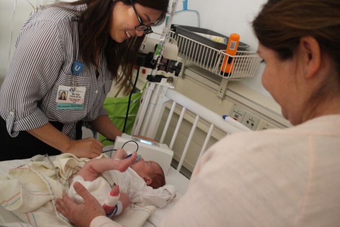 Music therapist Sandra Chea, left, with Julian Middleton and his mom Jamie Middleton during a music therapy session at UCLA Mattel Children's Hospital, Santa Monica.