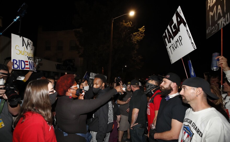 Members of the Proud Boys (R) and Black Lives Matter  protesters (L) confront each other during the vice presidential debate in Salt Lake City, Utah, on October 7,  2020. (Photo by GEORGE FREY / AFP) (Photo by GEORGE FREY/AFP via Getty Images)