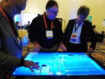 People sample a 3M Touch Systems 46-inch PCT-display demonstrating the scalability of projective capacitive technology at CES Unveiled, ahead of the opening of the annual Consumer Electronics Show, Jan. 8, 2012 in Las Vegas, Nevada. 