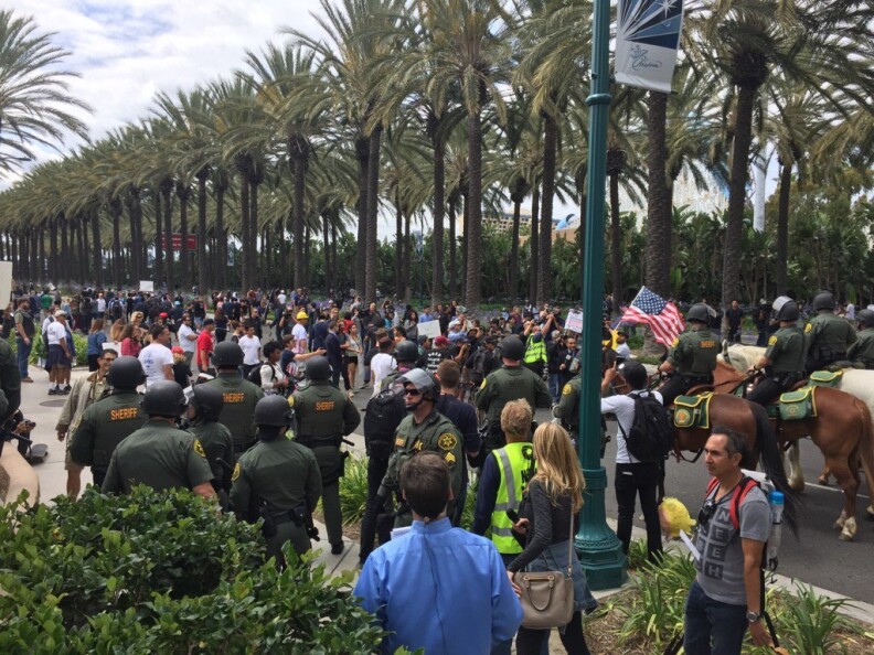 Law enforcement pushes a crowd of people down Katella following the Donald Trump rally in Anaheim on Wednesday, May 25, 2016.