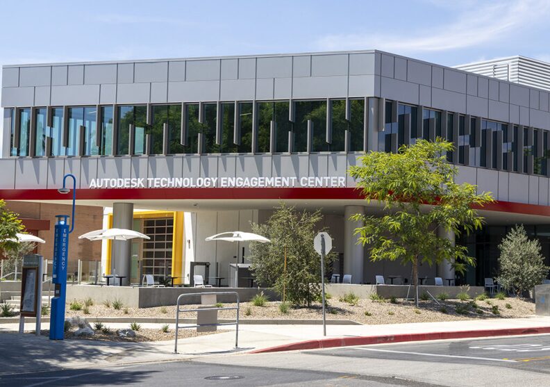 A gray building with red trim. Across the front, white letters display "Autodesk Technology Engagement Center."