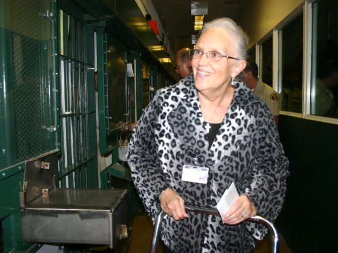 Patty Barlett, senior Catholic chaplain at Men's Central Jail, wishes inmates who weren't allowed to attend the morning church service. 