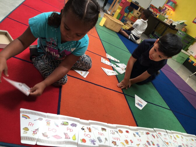 Kayleigh Perez, 5, and Jorge Moran Vargas, 5, line up alphabet cards in Pacific Elementary's transitional kindergarten class, Sacramento, CA. June 2016. 