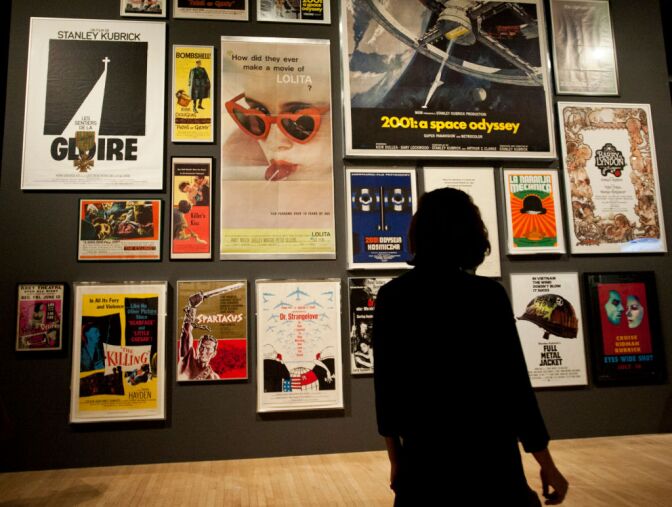 Viewers look at posters for Kubrick's films in the entrance to the exhibit. Kubrick is known for films such as "A Clockwork Orange," "2001: A Space Odyssey," and "Eyes Wide Shut."