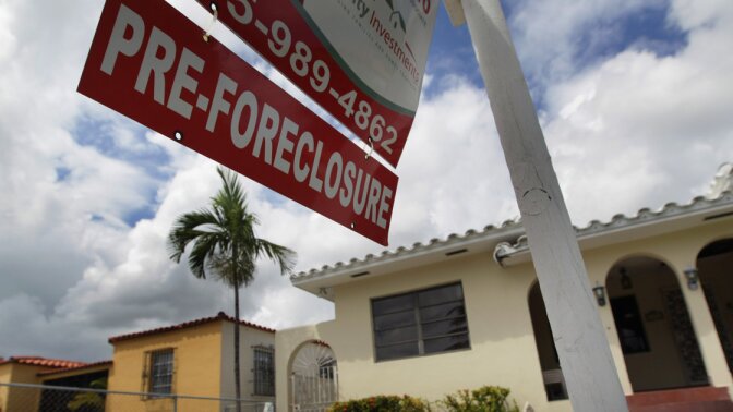 A sign hangs outside a house in Miami in 2010. Currently, Florida's foreclosure legal process can take a couple of years, which critics say is hurting the housing market.