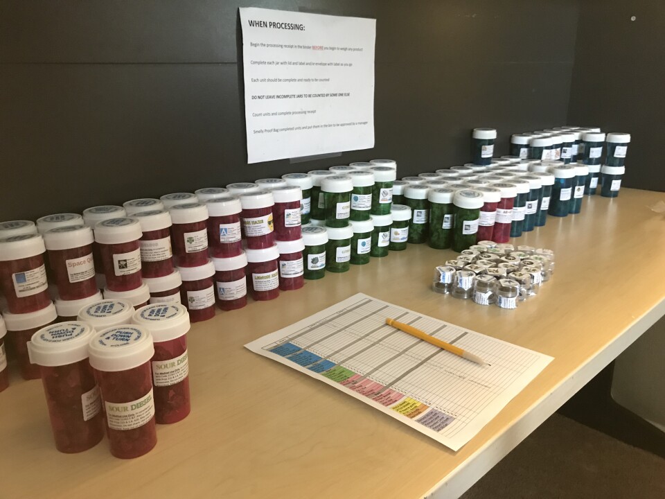 Vials of medical marijuana line a desk at the headquarters of a delivery service in south Orange County.