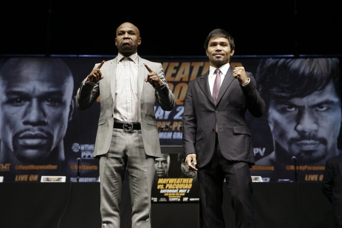 Boxers Floyd Mayweather Jr., left, and Manny Pacquiao, of the Philippines, pose for photos after a news conference, Wednesday, March 11, 2015, in Los Angeles. The two are scheduled to fight in Las Vegas on May 2. (AP Photo/Jae C. Hong)