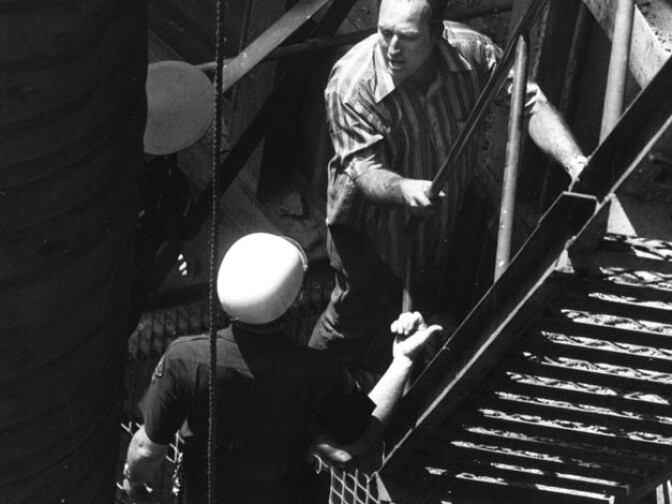 Miner John Wallace returns to the surface after being turned back by police. Wallace wanted to return to the tunnel, contending that the miners could do a better job of rescue in the mine than that of the fire department. He was the miner who discovered the only survivor, Ralph Brissette. When he returned to the surface, Wallace bitterly complained about the fire department's handling of the rescue attempts. Photograph dated June 24, 1971. 