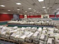 Scores of mail bins full of unopened mail-in ballots