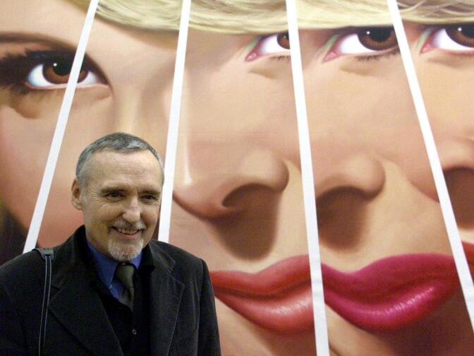 US actor and director Dennis Hopper poses in front of one of his art-works in the Stedelijk Museum in Amsterdam, 15 February 2001. The exhibition "Dennis Hopper (a keen eye) artist, photographer, filmmaker" will officially open here to public 17 February 2001. 