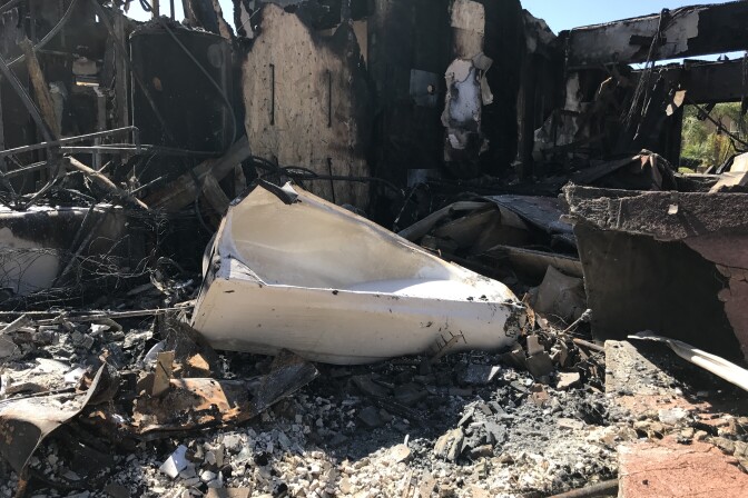 Fifteen homes were completely destroyed by the Canyon Fire 2 that raced through the Orange County hills in early October, fed by Santa Ana winds, heat and abundant, dry brush. Questions are now swirling over firefighters' initial response to the fire. 