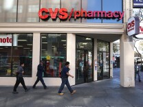 SAN FRANCISCO, CA - NOVEMBER 05:  Pedestrians walk by a CVS store on November 5, 2013 in San Francisco, California.  CVS Caremark reported a 25 percent surge in third-quarter earnings with profits of $1.25 billion, or $1.02 per share, compared to $1.01 billion, or 79 cents a share one year ago. (Photo by Justin Sullivan/Getty Images)
