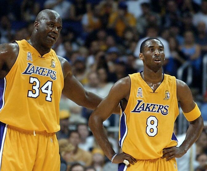 Shaquille O'Neal (L) and Kobe Bryant of the Los Angeles Lakers talk during the 1st quarter of game two of the NBA Finals against the New Jersey Nets 07 June 2002 at the Staples Center in Los Angeles, CA. The Lakers have a 1-0 lead in the best-of-seven series.  AFP PHOTO/Lucy NICHOLSON (Photo by LUCY NICHOLSON / AFP)        (Photo credit should read LUCY NICHOLSON/AFP via Getty Images)