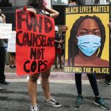 LOS ANGELES, CALIFORNIA - JUNE 23: Black Lives Matter-Los Angeles supporters protest outside the Unified School District headquarters calling on the board of education to defund school police on June 23, 2020 in Los Angeles, California. The demonstrators want the funds currently spent on campus police to be reallocated to other student-serving priorities.  (Photo by Mario Tama/Getty Images)
